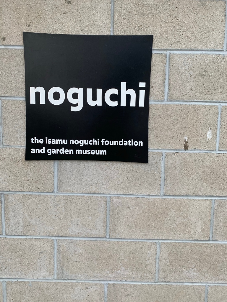 the simple sign says: 
noguchi

the isamu noguchi foundation and garden museum.

